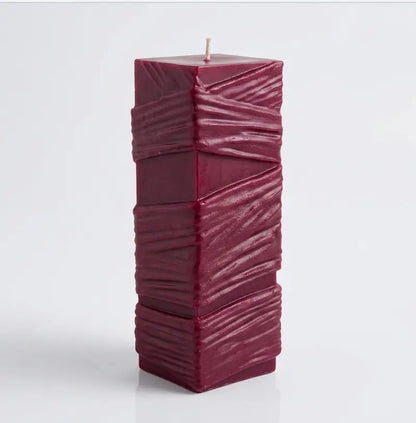 Custom Candle - Large Sculptural Design in deep burgundy color with a textured surface.