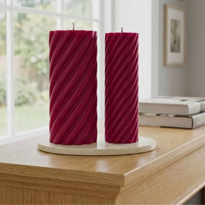 Pillar Candle Set featuring two spiral columns in vibrant magenta displayed on a decorative tray.