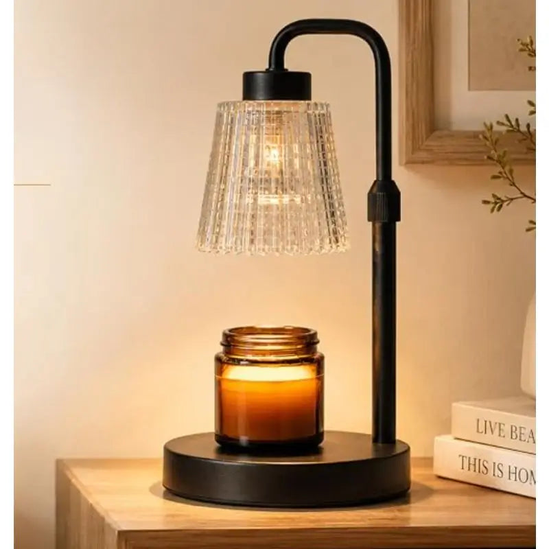 Candle Warmer Lamp with Dimmer and Timer illuminating a wickless candle on a bedside table.