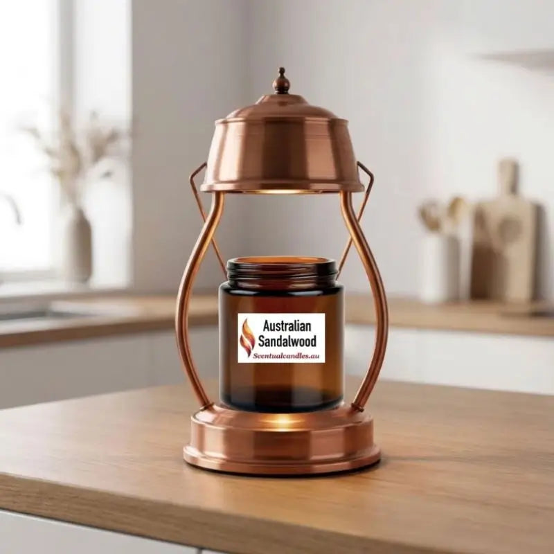 Candle Warmer Lantern with Dimmer and Timer heating a candle in a copper finish on a wooden tabletop.