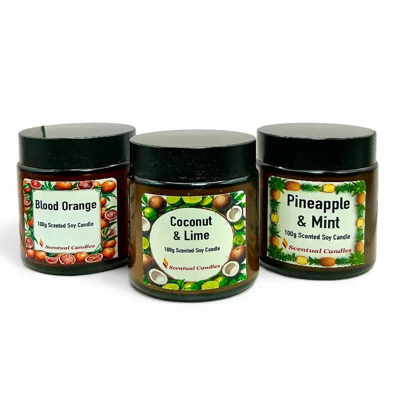 Three scented candles with labels for Blood Orange, Coconut & Lime, and Pineapple & Mint on a white background.
