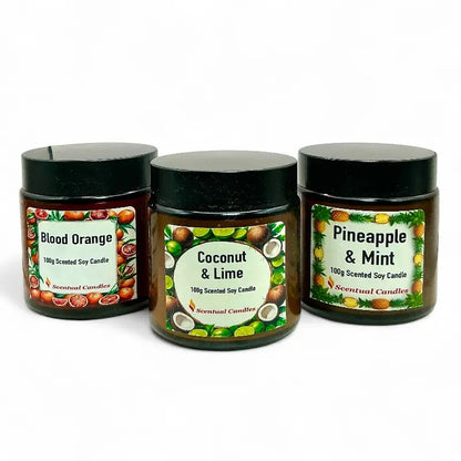 Three scented candles with labels for Blood Orange, Coconut & Lime, and Pineapple & Mint on a white background.