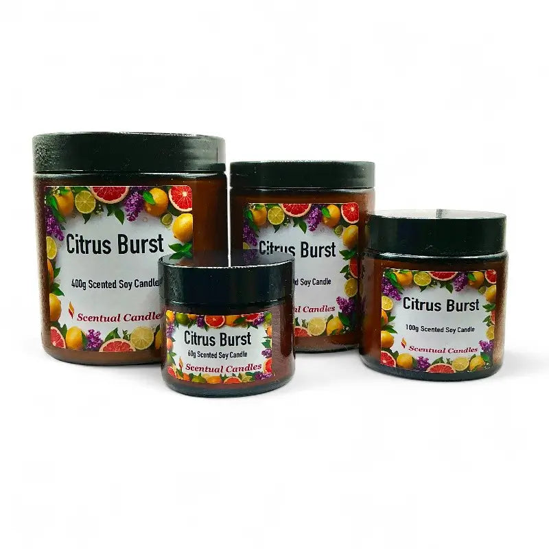 Four Citrus candle with colorful fruit illustrations on labels against a white background.