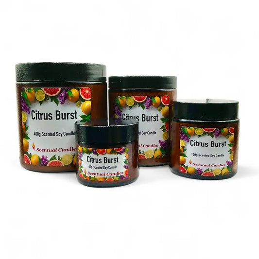 Four Citrus candle with colorful fruit illustrations on labels against a white background.