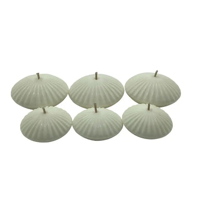 Set of six ribbed floating candles on a white background