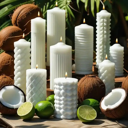 White pillar candles with coconuts and limes on a wooden surface