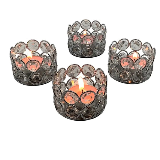 Set of four decorative candle holders with candles on a white background