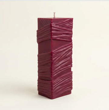 Custom Candle in large sculptural design, hand-poured with a rich burgundy color and textured surface.