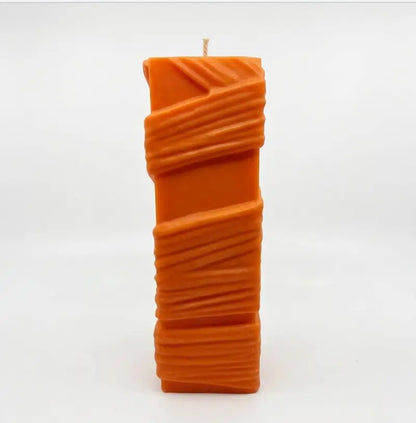 Custom Candle in large sculptural design, hand-poured orange wax with unique textured details.