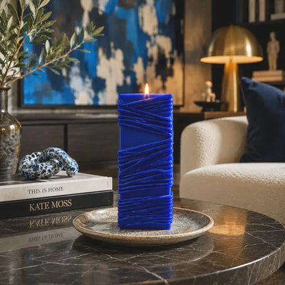 Custom Candle with large sculptural design, hand-poured in vibrant blue, displayed elegantly on a table.