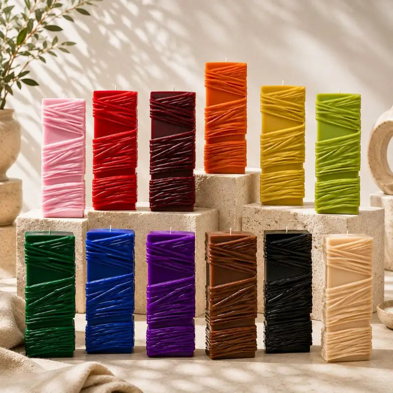 Custom Candle collection showcasing large sculptural designs in various colors on decorative stands.
