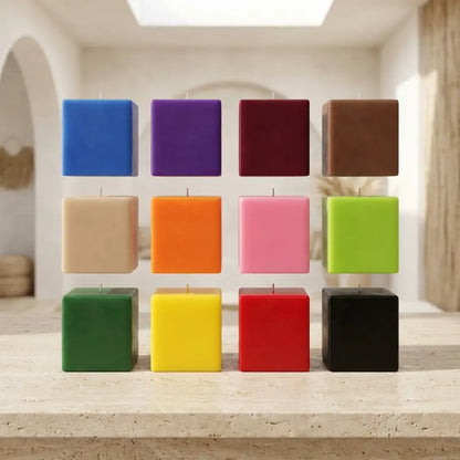 Assorted colors of Extra Large Customisable Candle pillars arranged on a rustic surface