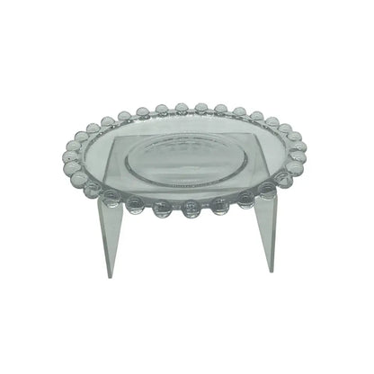 Clear glass candle plate on a stand with a white background