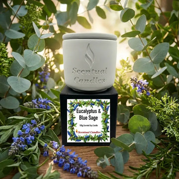 Scentual Candles Eucalyptus Candle with Blue Sage surrounded by greenery and flowers