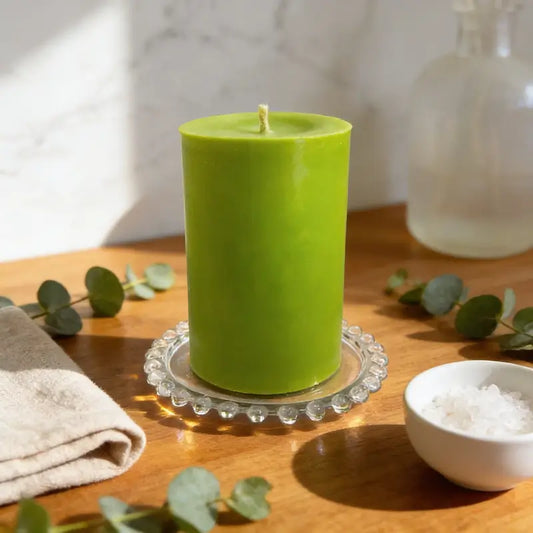 Extra Large Pillar Candle 1.1kg in green on a glass holder with decorative elements around it, showcasing fragrance and style.