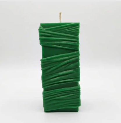 Custom Candle - Large Sculptural Design in green, featuring a unique texture with elegant wrapping detail.