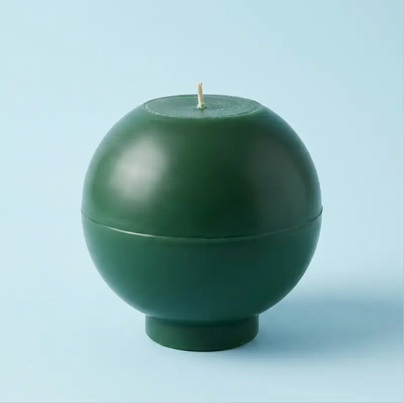 Round Candle in dark green color with a smooth spherical design and wick. Ideal for customisable colour and scent.