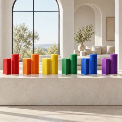 Colorful Geometric Pillar Candle set displayed on a countertop with a bright modern interior.