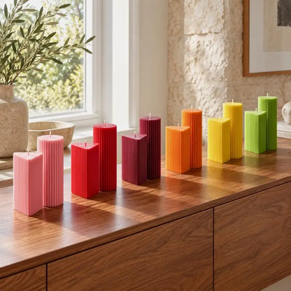 Geometric Pillar Candle Set displaying colorful ribbed candles in various heights on a wooden surface.