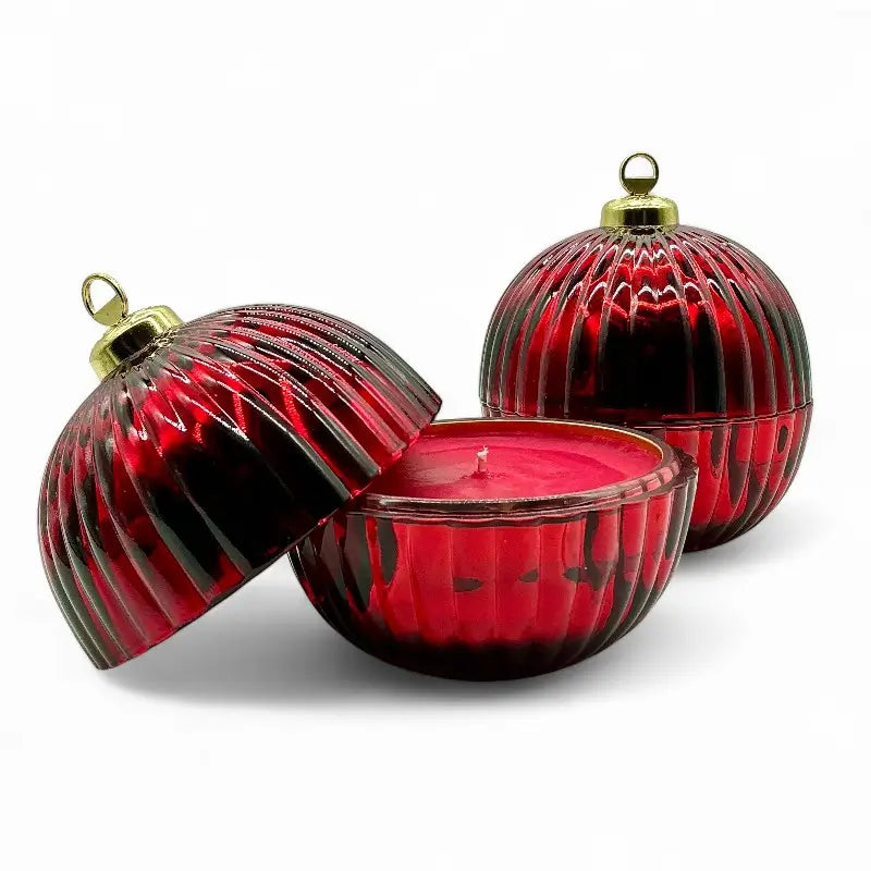 Red Glass Bauble Christmas Scented Candles with gold top, perfect festive decor and fragrant gift option, displayed in decorative bauble jars.