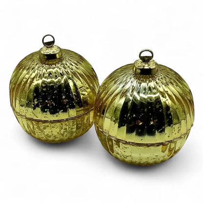 Two gold reflective glass bauble christmas ornaments on a white background