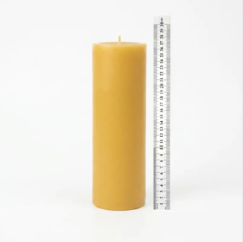 Giant Pillar Candle shown with a ruler for scale, measuring 27cm tall and 9cm in diameter.