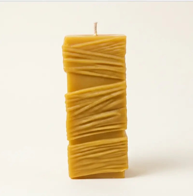Custom Candle in a large sculptural design with textured yellow wax and a single wick.