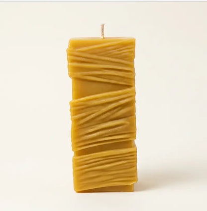 Custom Candle in a large sculptural design with textured yellow wax and a single wick.