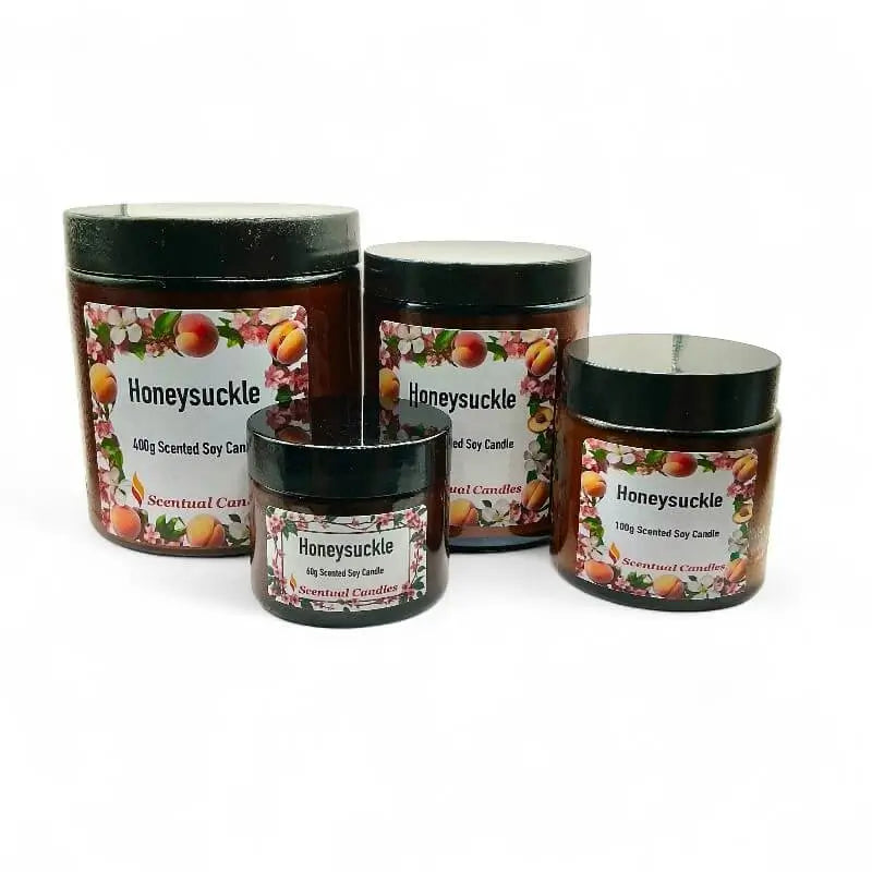 Four Honeysuckle scented candle with decorative labels on a white background
