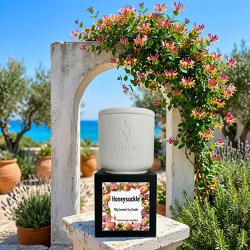 Honeysuckle Candle surrounded by blooming honeysuckle flowers in a serene garden setting.