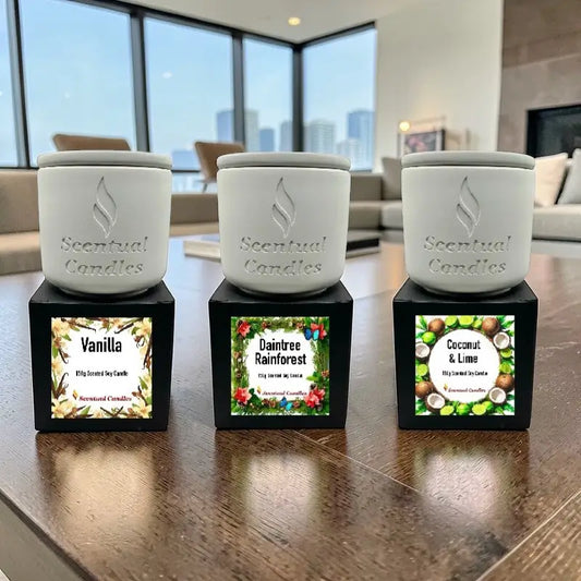 Housewarming Candle Gift Pack with 3 scented candles: Vanilla, Daintree Rainforest, Coconut & Lime displayed on a table.