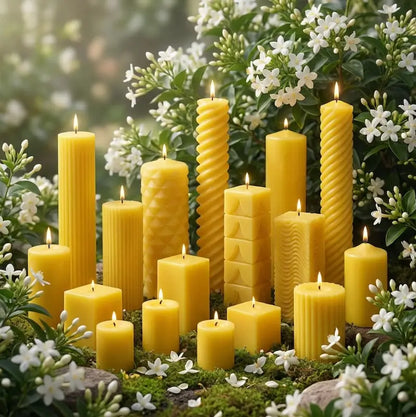 Jasmine scented yellow candles of various shapes and sizes on a natural background with greenery and white flowers.