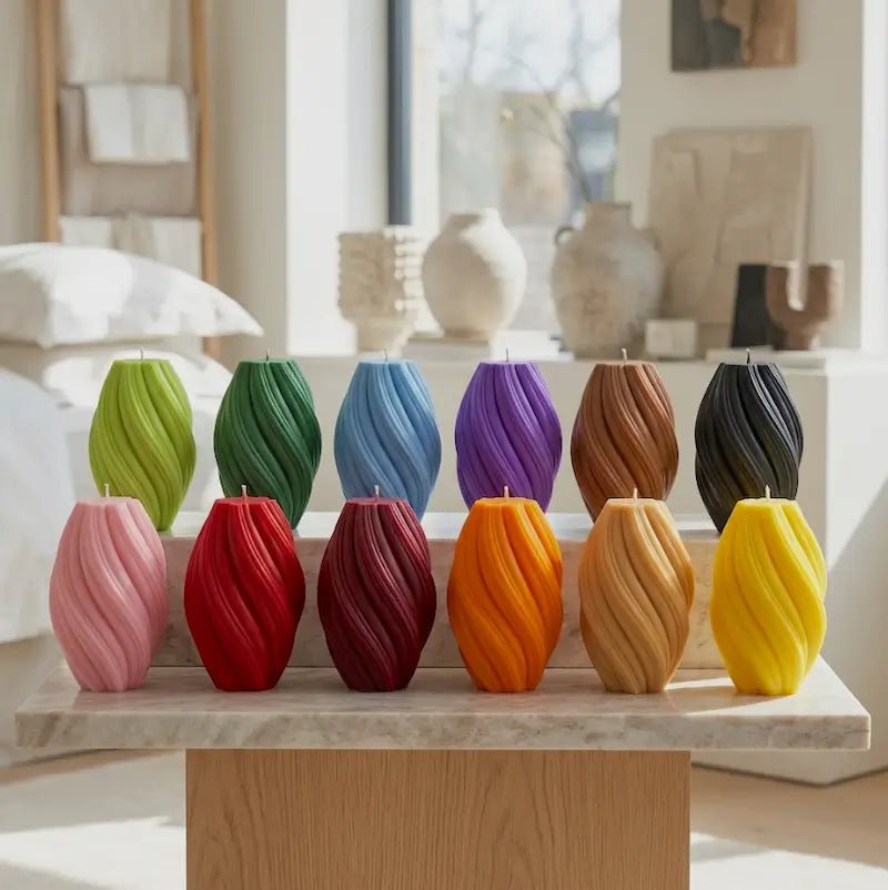 Colorful Large Pillar Candles in swirly shapes, displayed on a wooden table, highlighting handcrafted design and premium quality.