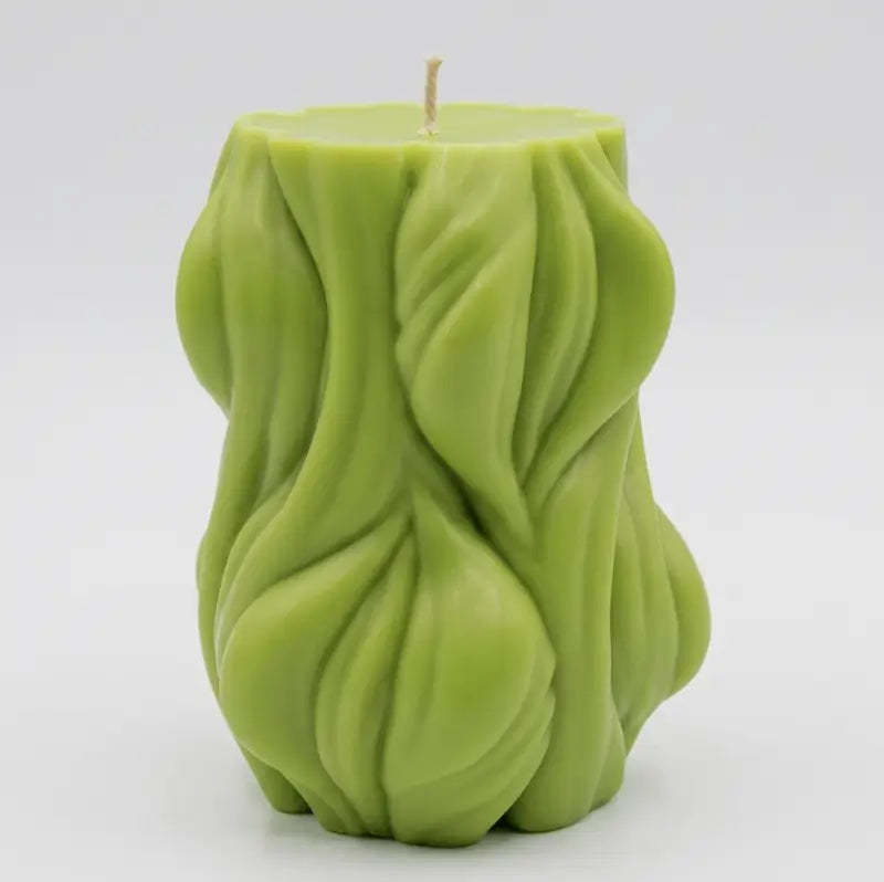 Decorative Candle in green, designed with a flowing texture, ideal for adding style and fragrance to any space.