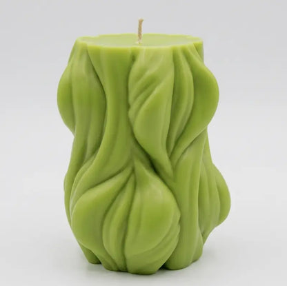 Decorative Candle in green, designed with a flowing texture, ideal for adding style and fragrance to any space.