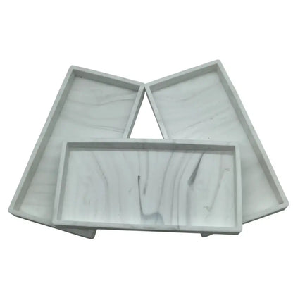 Three gray plastic trays on a white background