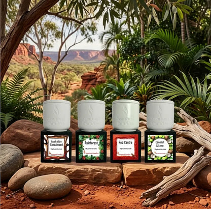 Masculine Candles set featuring Australian Sandalwood, Rainforest, Red Centre, Coconut & Lime in a natural outdoor setting.