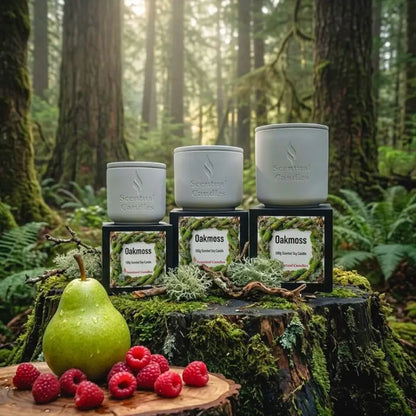 Image of Oakmoss Candle displayed among forest greenery with pear and raspberries on a log.