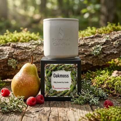 Oakmoss Candle displayed with a pear and raspberries in a serene forest setting, showcasing its fresh and woody fragrance.