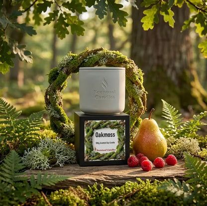 Oakmoss Candle displayed in a natural setting with eucalyptus, pear, and mossy elements.