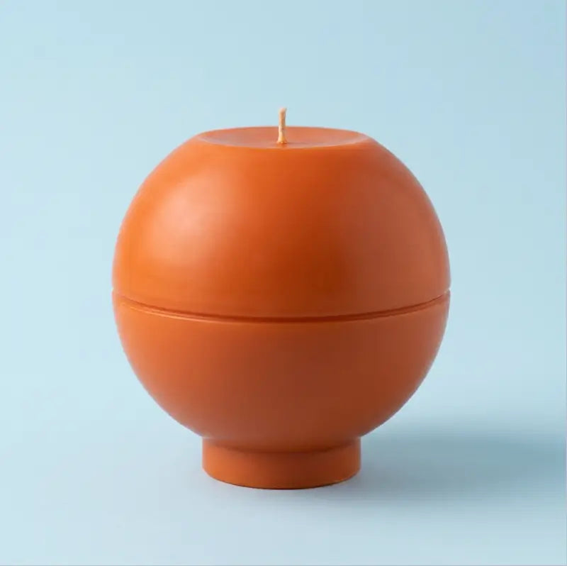 Round Candle in orange color, customizable scent, sculptural design, weighing 1.65kg, perfect for home decor.