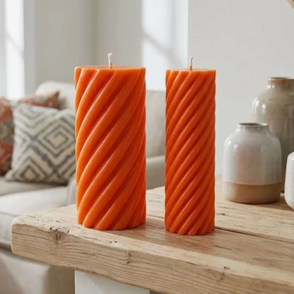 Pillar Candle Set featuring two spiral columns in vibrant orange, enhancing home decor with elegant lighting.