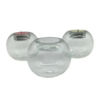 Three orb glass candle holders on a white background
