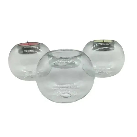 Three orb glass candle holders on a white background