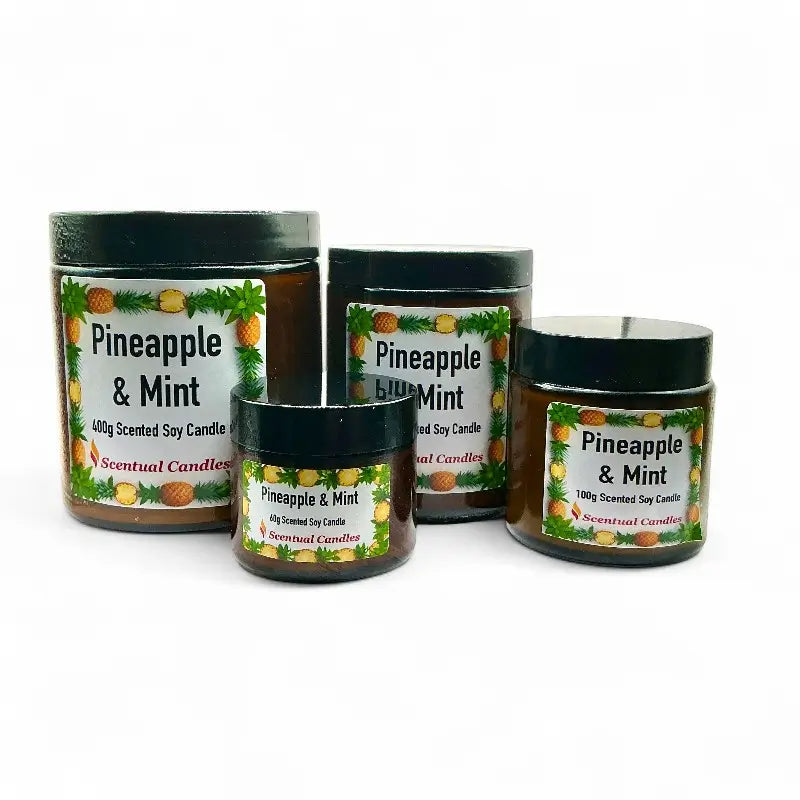 Four Pineapple and Mint scented candles of different sizes on a white background
