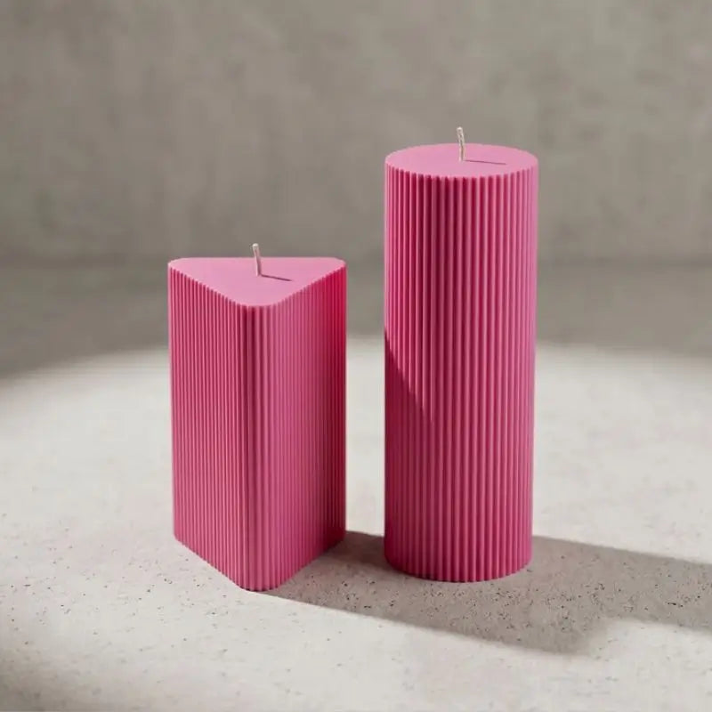Geometric Pillar Candle Set showcasing a pink ribbed triangle and tall column for a sculptural display.