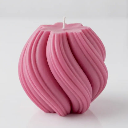 Ball Candle in a bold pink color, featuring a sculptural twisted design.