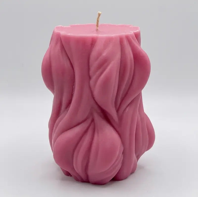 Decorative Candle in a unique pink design, showcasing a sculptural texture, perfect for modern home decor.