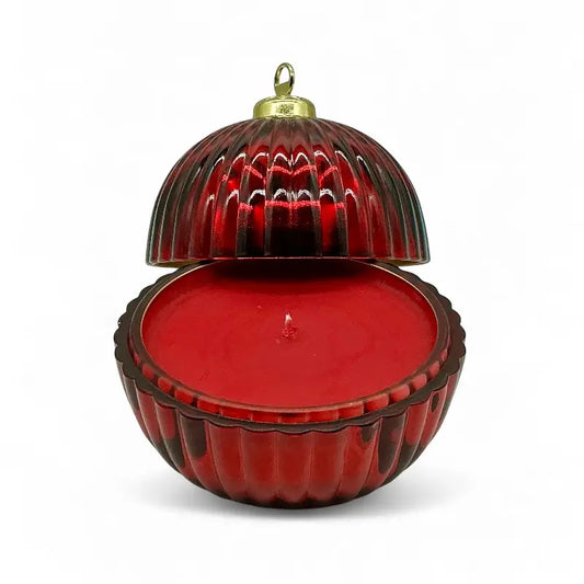 Glass Bauble Christmas scented candle in red ribbed glass jar with gold top, open to reveal festive red wax, ideal holiday ornament.