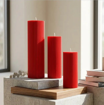 Ribbed Candles - Set of 3 Pillars in red, showcasing varying heights and vertical ribbing for decorative displays.